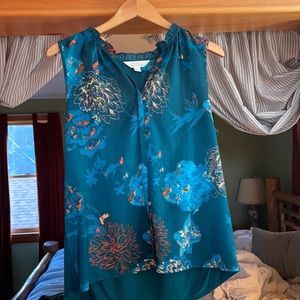 Large, sleeveless, polyester and rayon top with a floral print.